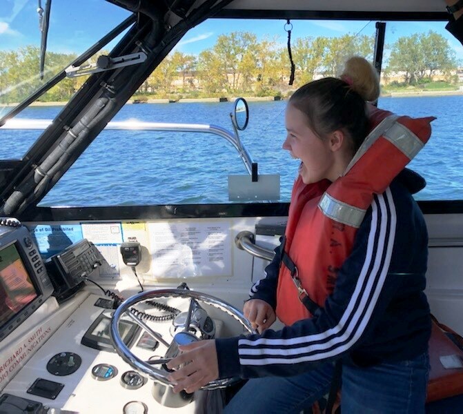 Participant enjoying an accessible boating experience with Excalibur Leisure Skills Center